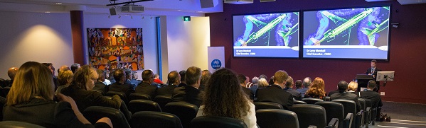 Audience watching presentation at event