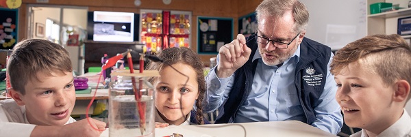 STEM Professional teaching children in classroom