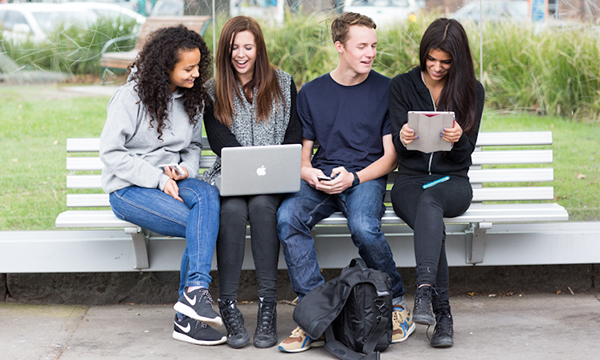 Group of people looking at a laptop together