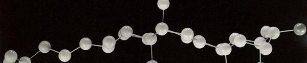 Chemical structure model with plastic balls attached by long wire