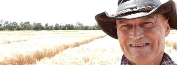 CSIRO Alumni member Paul Sims in a field of BarleyMax