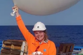 Hannah McCleary with a weather balloon on board RV Investigator.