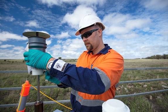 Researcher checks air quality monitoring equipment adjacent to a coal seam gas well near Roma in Queensland's Surat Basin