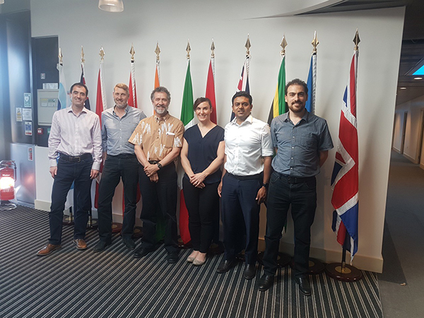 People in front of flags