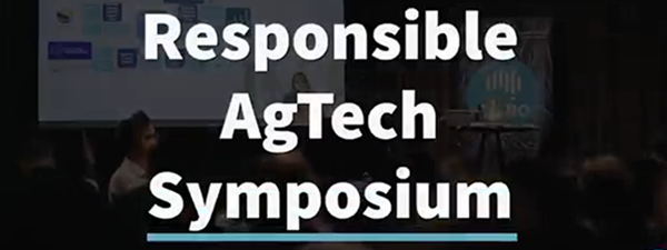 A screenshot of a video. The frame has text which says "responsible agtech symposium" and the background is a conference room.