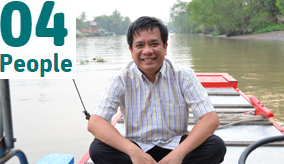 Dr Minh Nguyen on a boat in Vietnam