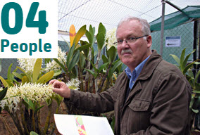 Mark Clements in greenhouse with orchids