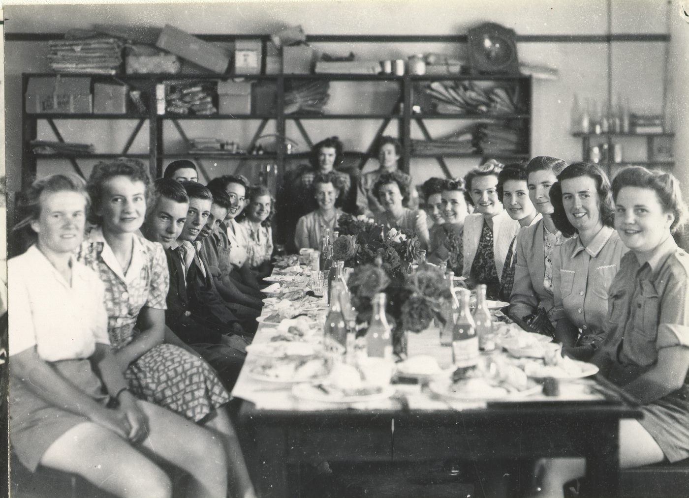 black and white photo of a group of mainly women sitting around a table