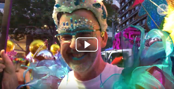 person in sparkly blue make-up and costume at mardi gras