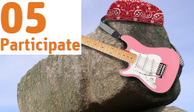 a rock with a bandana an a pink electric guitar on it