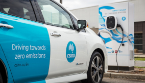 a blue and white car at an electric charging station