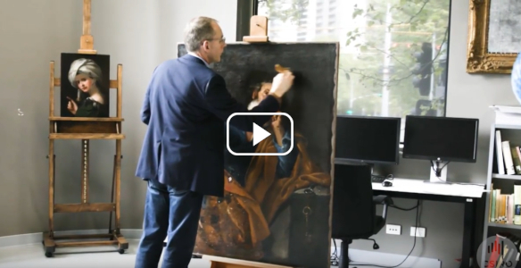 a man in a suit painting over an artwork in a studio