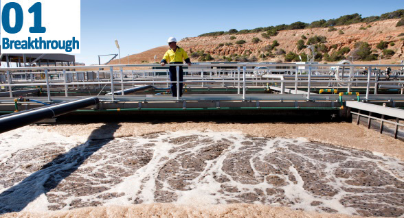Man standing over sewage treatment